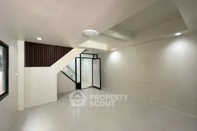 Spacious modern living room with sleek design and ample natural light, perfect for contemporary living.