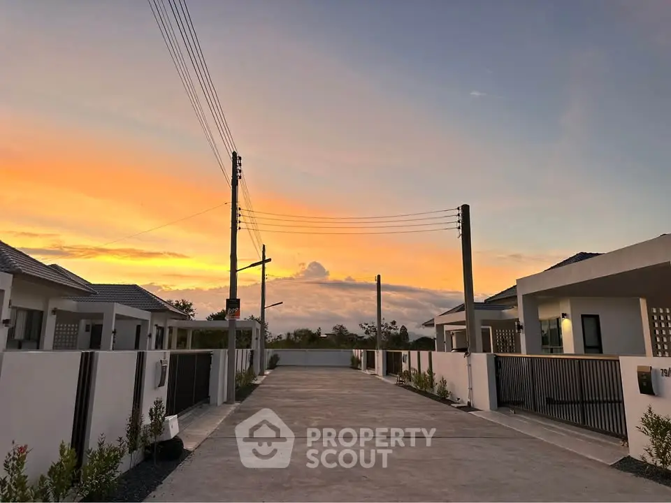 Charming suburban homes at sunset with serene driveway and modern architecture.
