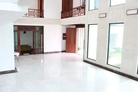 Spacious modern living room with large windows and high ceilings