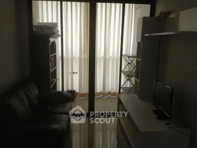 Cozy living room with sleek furniture and large window for natural light.