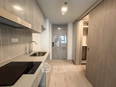 Modern kitchen with sleek cabinetry and built-in appliances in a contemporary apartment.