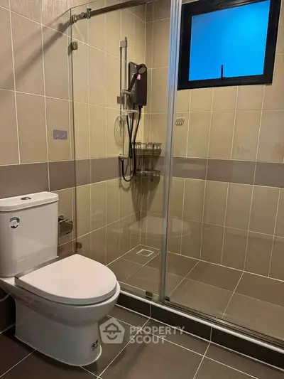 Modern bathroom with glass shower enclosure and sleek tile design