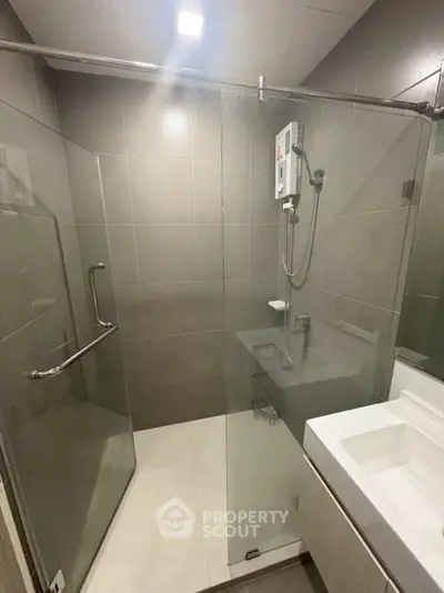Modern bathroom with glass shower enclosure and sleek fixtures