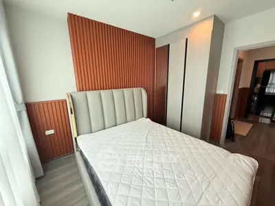 Modern bedroom with stylish wood paneling and sleek wardrobe design.