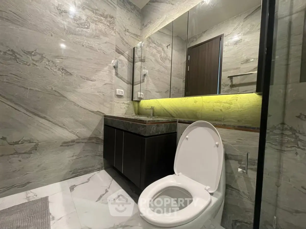 Luxurious modern bathroom with marble walls and sleek fixtures