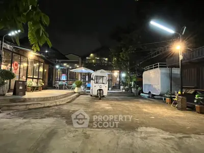 Charming night view of a cozy courtyard with ambient lighting and unique architecture.