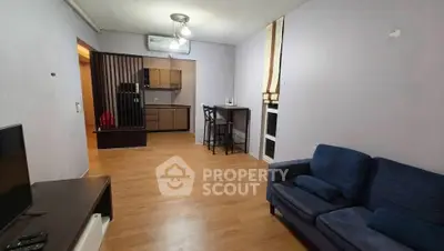 Spacious living room with modern kitchen and cozy seating area