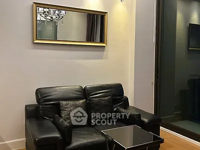Modern living room with black leather sofa and elegant mirror decor
