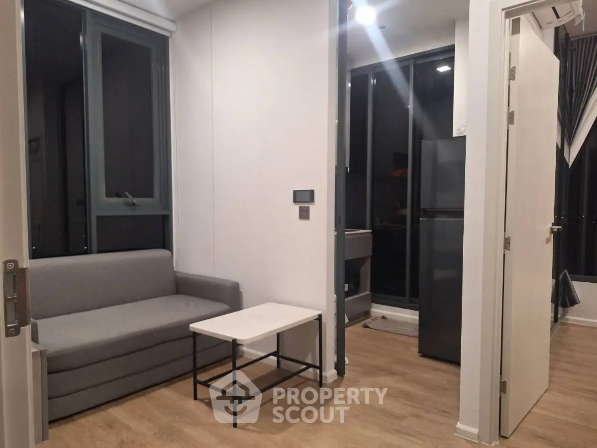 Modern apartment interior with cozy living area and sleek kitchen design.