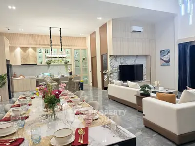 Luxurious open-plan living room with elegant dining area and modern kitchen