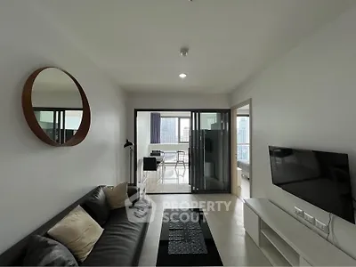 Modern living room with sleek furniture and city view balcony, perfect for urban living.