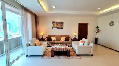 Spacious living room with modern decor and city view balcony