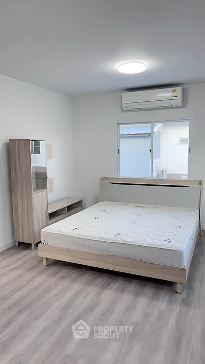 Modern minimalist bedroom with wooden furniture and natural light