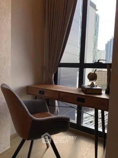 Cozy study nook with city view, featuring a stylish desk and comfortable chair.