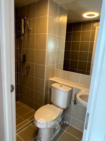 Modern bathroom with sleek tiles and contemporary fixtures in a stylish apartment.