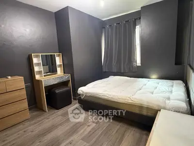 Modern bedroom with sleek dark walls and minimalist furniture design