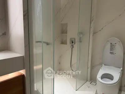 Modern bathroom with glass shower and sleek toilet design