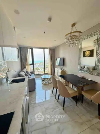 Luxurious open-plan living room with stunning sea view, elegant dining area, and modern kitchen.
