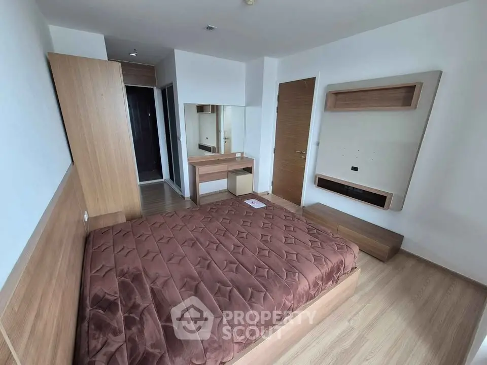 Modern bedroom with wooden furniture and cozy brown bedding