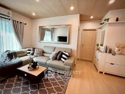 Stylish living room with modern decor, cozy seating, and elegant lighting.