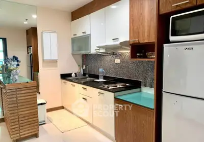 Modern kitchen with sleek cabinetry and appliances in a stylish apartment.