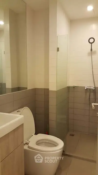 Modern bathroom with sleek shower and contemporary fixtures in a stylish apartment.