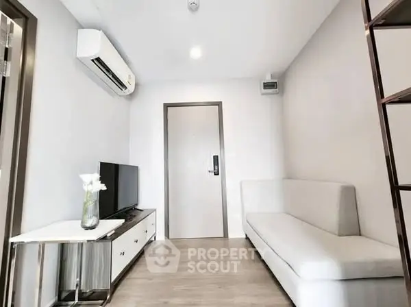 Modern living room with sleek furniture and air conditioning, perfect for urban living.