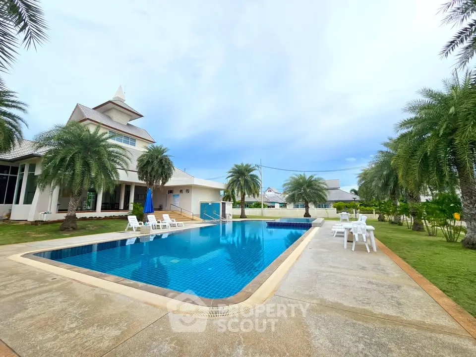 Luxurious villa with stunning pool and tropical garden, perfect for relaxation and entertainment.
