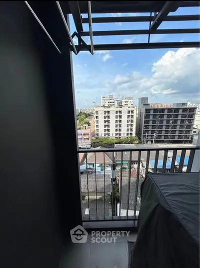 Urban balcony with city view, perfect for enjoying skyline vistas and fresh air in a modern apartment setting.