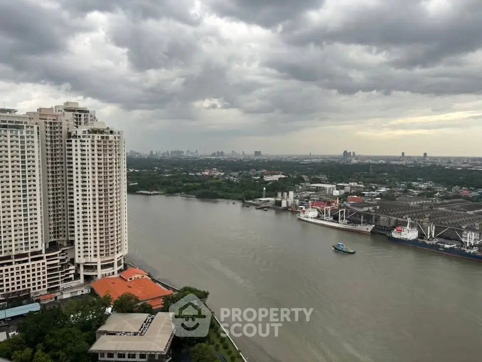 Stunning river view from high-rise apartment with city skyline backdrop, perfect for urban living enthusiasts.