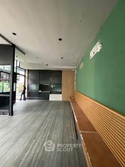 Spacious commercial space with modern flooring and large windows