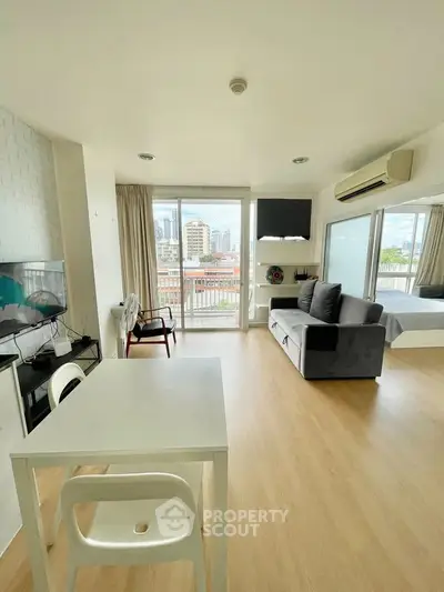 Modern open-plan living room with city view and stylish furnishings