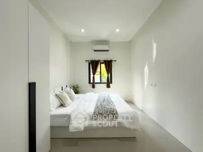 Spacious minimalist bedroom with modern decor and natural light