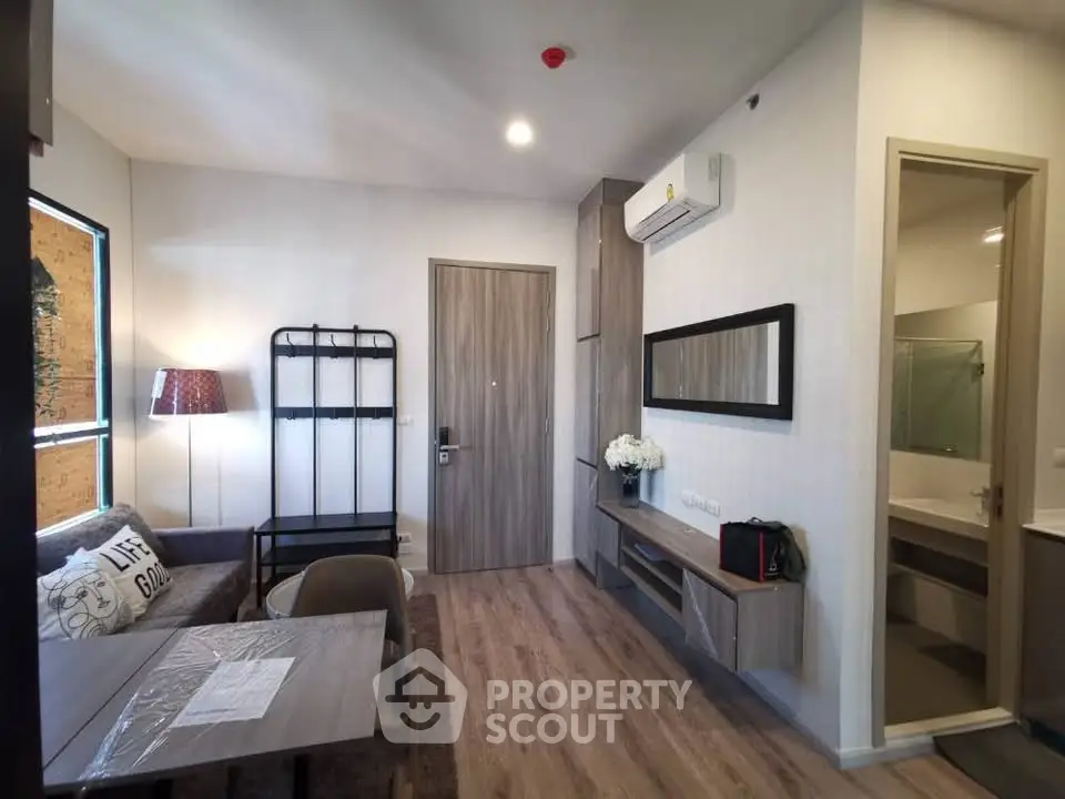 Modern living room with stylish decor and open layout, featuring a cozy seating area and dining space.