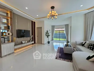 Spacious modern living room with elegant decor and large windows offering natural light.