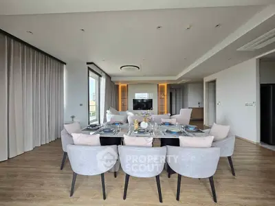 Luxurious open-plan living and dining area with elegant decor and ample natural light.