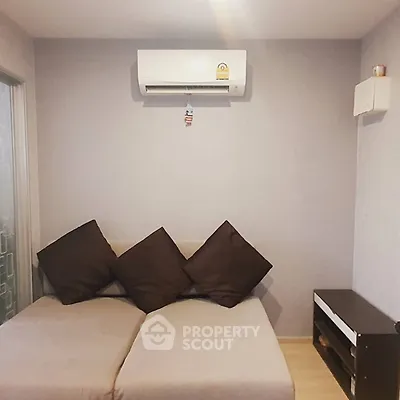Cozy living room with modern air conditioning and stylish sofa, perfect for relaxation.