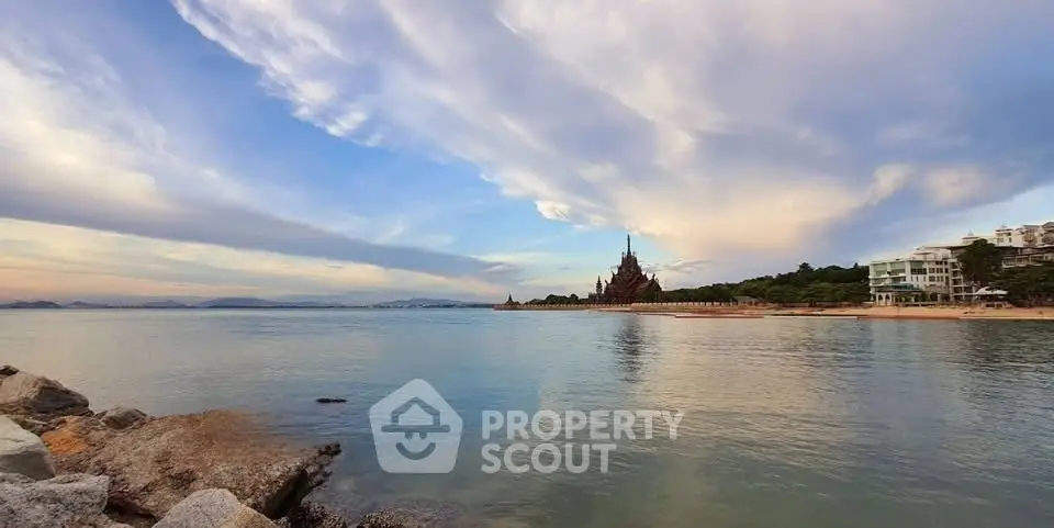 Stunning beachfront view with unique architectural landmark and serene ocean backdrop.