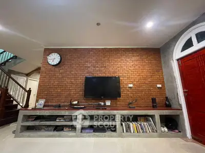 Stylish living room with exposed brick wall and modern entertainment setup