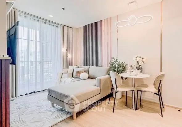 Modern living room with stylish decor and large windows offering natural light.