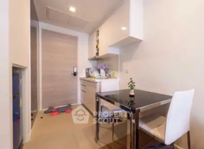 Modern kitchen with sleek dining area and compact design