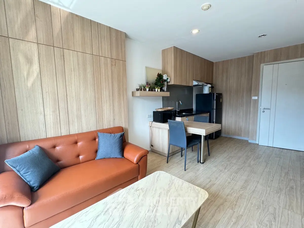 Modern living room with stylish furniture and open kitchen layout