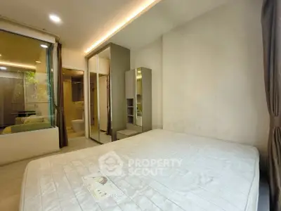 Modern bedroom with large mirror wardrobe and natural light