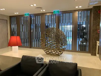 Luxurious lobby with modern sculpture and elegant seating area