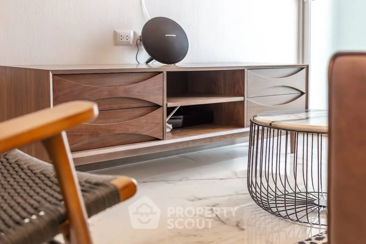 Stylish modern living room with elegant wooden furniture and sleek marble flooring.