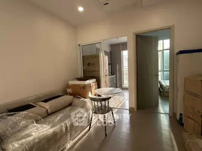 Modern apartment interior with cozy living room and bedroom view, featuring natural light and stylish furniture.