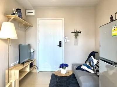 Cozy living room with modern decor and compact furniture arrangement.