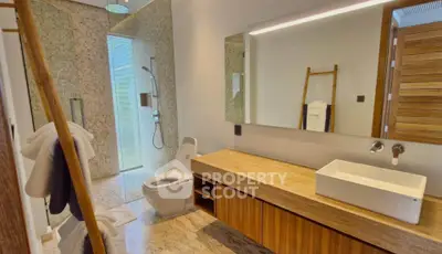 Luxurious modern bathroom with elegant fixtures and natural stone accents