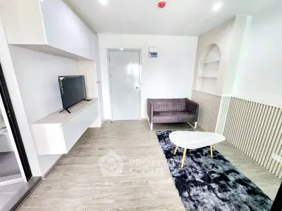 Modern living room with sleek design, featuring a wall-mounted TV, stylish sofa, and contemporary decor.