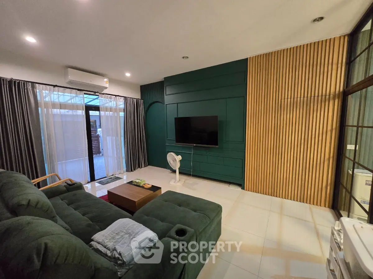 Modern living room with stylish green accent wall and cozy seating area